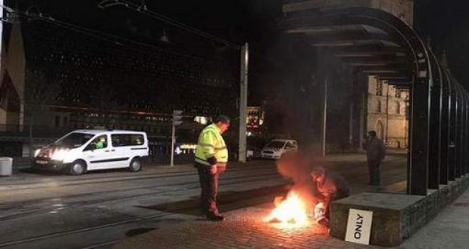 Evsiz adam tarihi Gent şehrinin merkezinde ısınmak için ateş yaktı